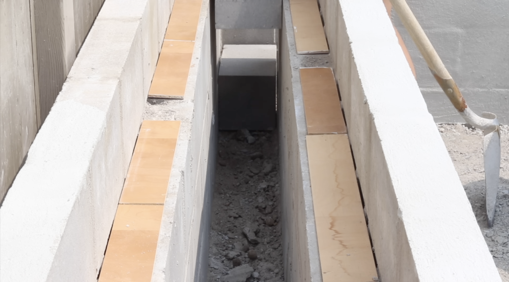 putting wood over the holes in the cinder blocks in the DIY Raised Concrete Garden Bed